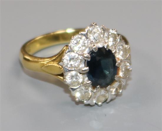 A 1970s 18ct gold, sapphire and diamond set oval cluster ring, size M.